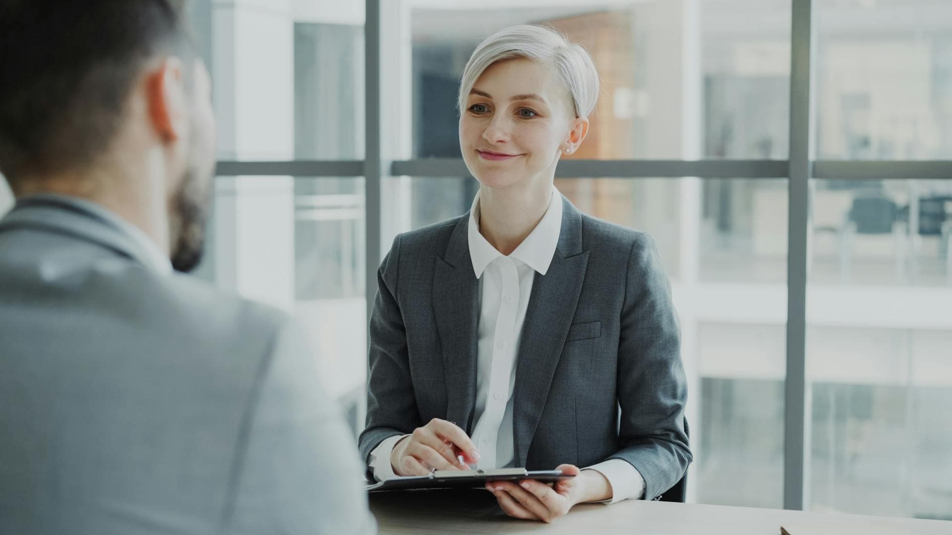 A career consultant reviewing a finished resume with a candidate in a professional setting